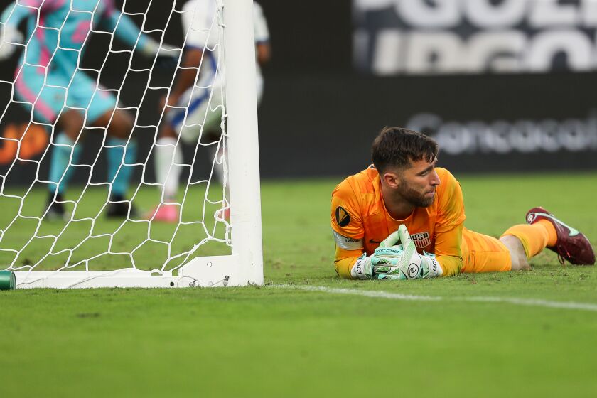 USMNT Keeper Matt Turner looks on from the pitch in dismay as Panama celebrates Adalberto Carrasquillas winning penalty.